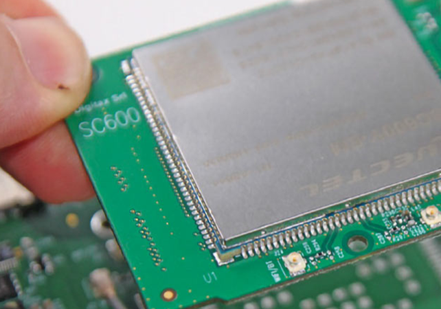 close-up view of a digitax android soc hardware module being installed on a circuit board, illustrating the upgradable android platform for long-term compatibility and fleet management systems.