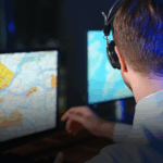 police dispatch operator monitoring field units from the control room