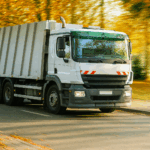 waste management vehicle operating on an urban road